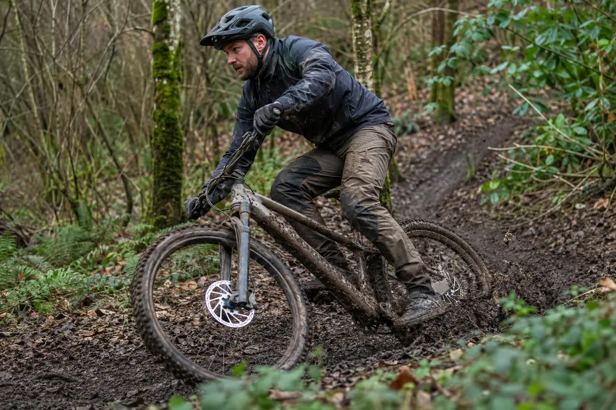 Mountain biker wearing trail trousers in British woodland