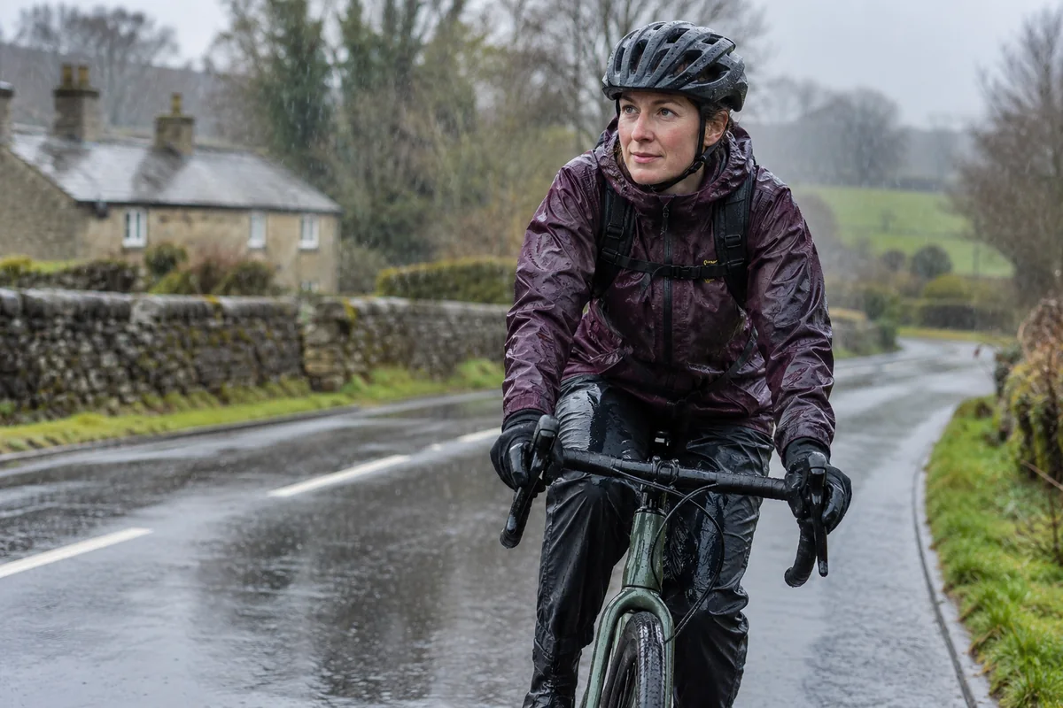 Cyclist or mechanic demonstrating practical considerations for Cycling in rain: how to stay comfortable