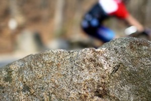 Cycling past a rock